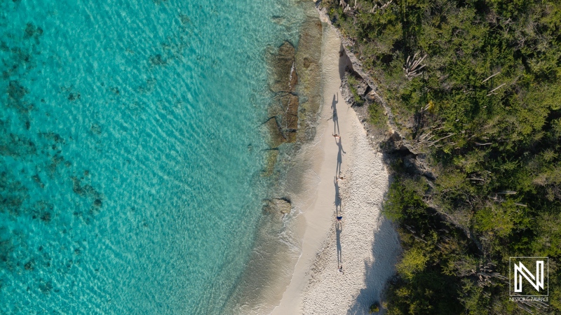 Family and friends enjoying a sunny day on the pristine beaches of Curacao with vibrant turquoise waters and soft white sand