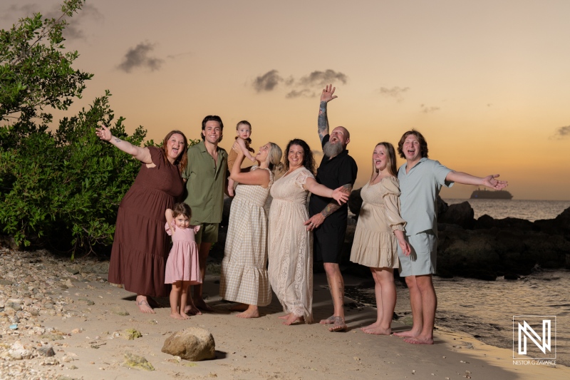 Family and friends enjoy a joyful gathering on the beach in Curacao during sunset, creating cherished memories together