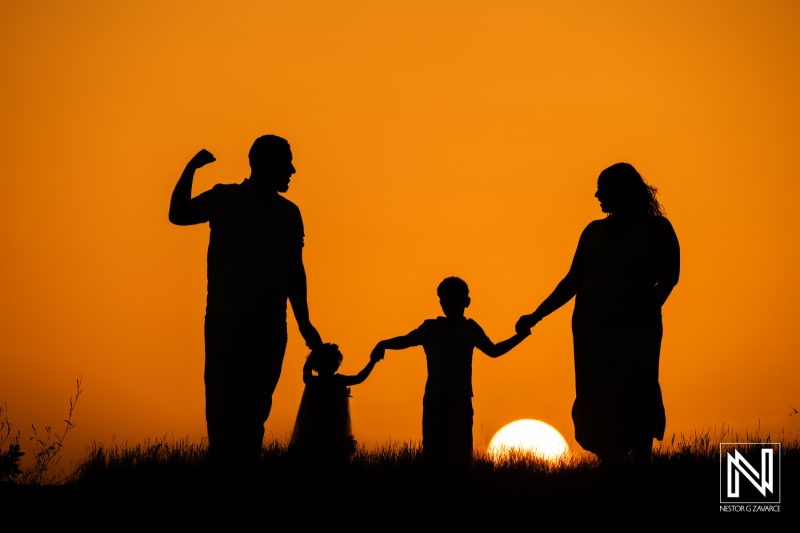 Family and friends enjoy a memorable photoshoot during sunset in Curacao, creating lasting memories against a beautiful backdrop