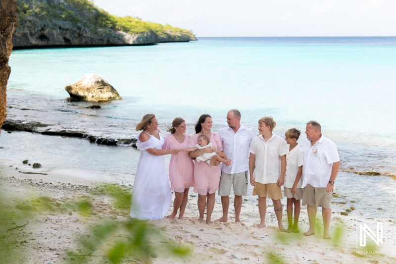 Family gathering on the beach during vacation in Curacao with friends and loved ones