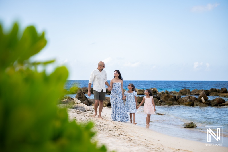 Family enjoys time together during vacation in Curacao on the beach with friends and children