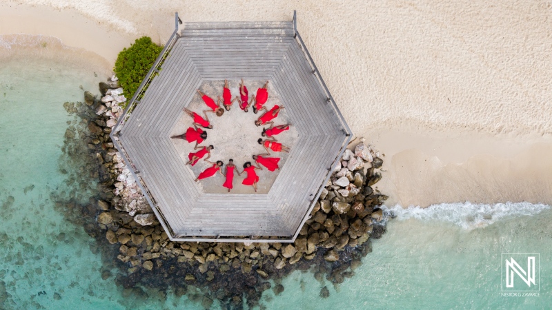 Family and friends gather for a photoshoot on a deck by the beach in Curacao during vacation
