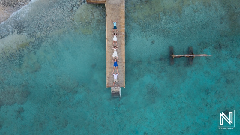Family gathers on a dock in Curacao for a fun vacation photoshoot with friends