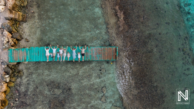 Family enjoys a vacation together on a dock in Curacao during a sunny day