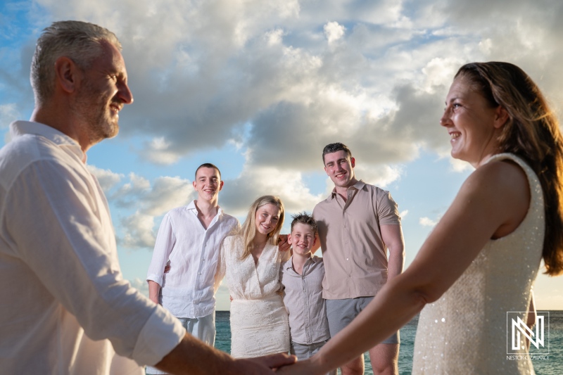 Family gathers for a fun photoshoot during vacation in Curacao with friends on the beach