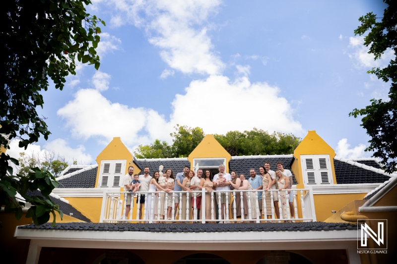 Family and friends gather for a photoshoot on a balcony in Curacao during their vacation