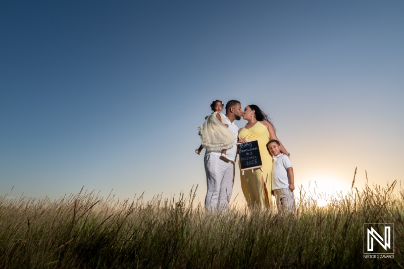 Maternity celebration at sunset on the beautiful beaches of Curacao with family embracing love and new beginnings