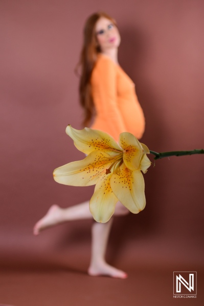 Celebrating motherhood in Curacao with a beautiful maternity photoshoot featuring a blooming flower and a pregnant model