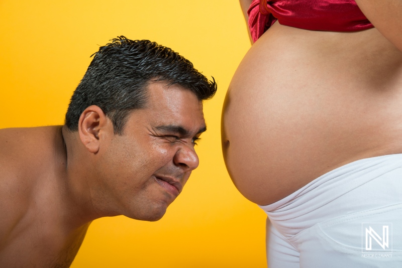 Maternity celebration in Curacao with joyful father anticipating the arrival of their baby during a vibrant photoshoot