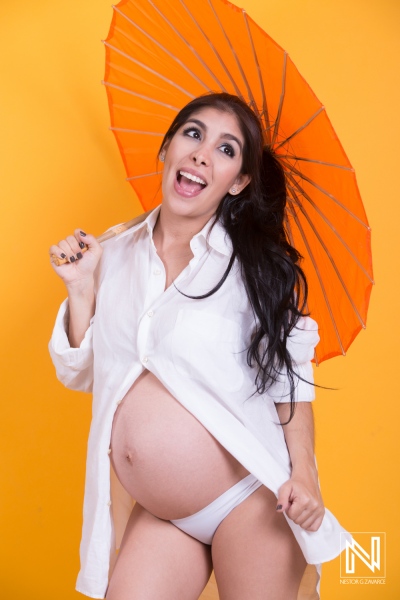 Expecting joy in Curacao with bright colors and playful spirit during a maternity photoshoot