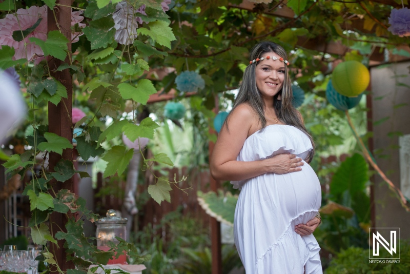 Beautiful maternity celebration in Curacao with expecting mother surrounded by vibrant greenery