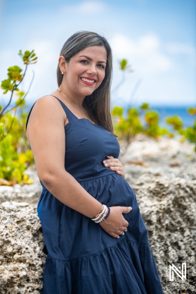 Expecting joy in Curacao with a beautiful maternity moment by the ocean during a sunny day