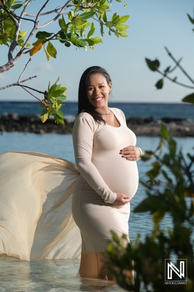 Beautiful maternity portrait of a pregnant woman by the shore in Curacao, showcasing natural beauty and serenity during pregnancy