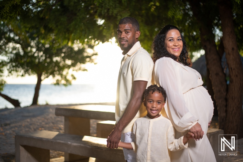 Pregnant couple with child enjoying sunset in Curacao during maternity photo session