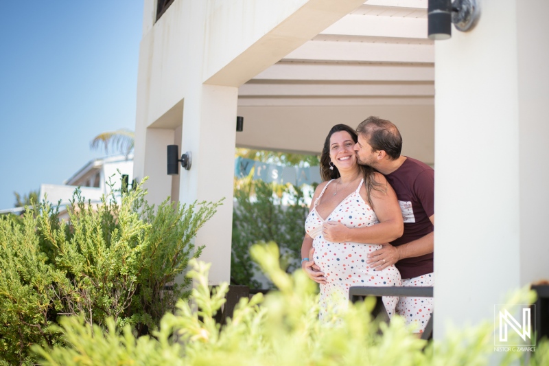 Expecting joy in Curacao as a couple celebrates pregnancy with heartfelt moments on a sunny day surrounded by greenery