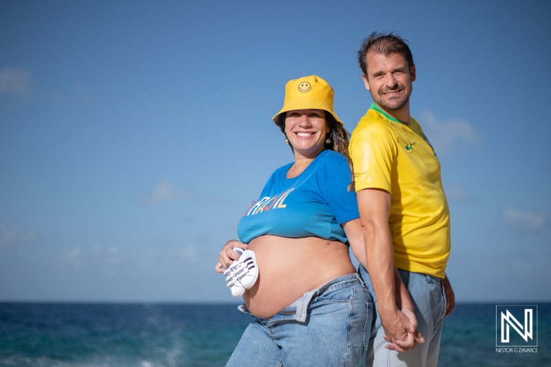 Maternity celebration on the beaches of Curacao with expectant couple enjoying the ocean view