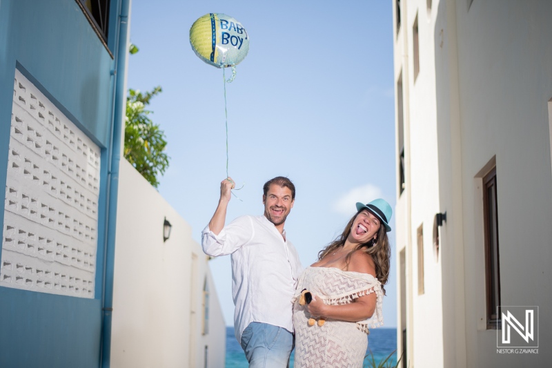 Expecting joyful parents celebrating impending arrival in Curacao's beautiful seaside atmosphere