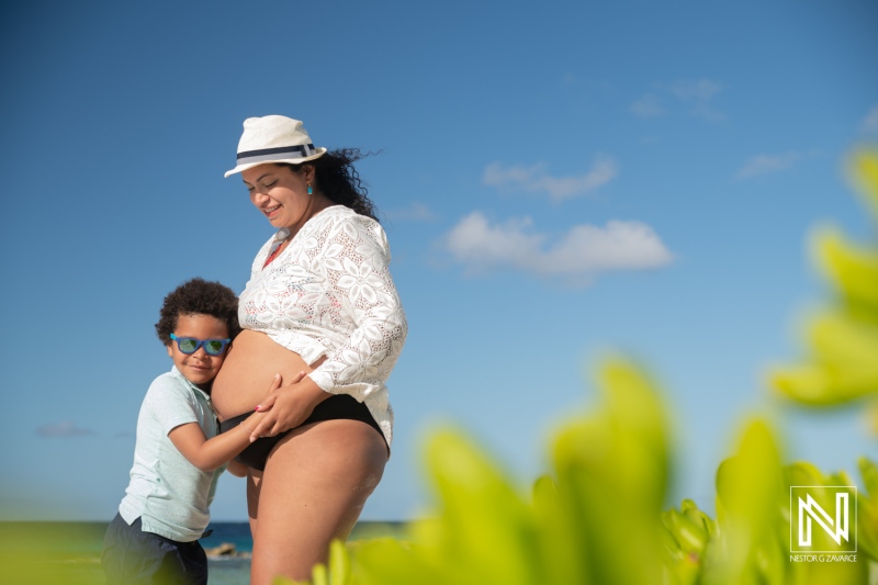 Expecting a new life on the beach in Curacao with joyful moments between mother and son