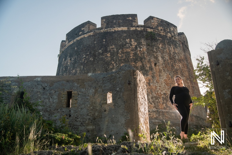 Maternity session at historic fort in Curacao during golden hour highlighting the beauty of pregnancy