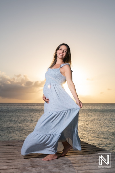 Expecting joy on the shores of Curacao during sunset with beautiful maternity fashion