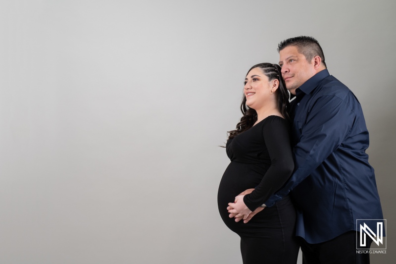 Maternity portrait in Curacao celebrating pregnancy with loving couple in stylish attire