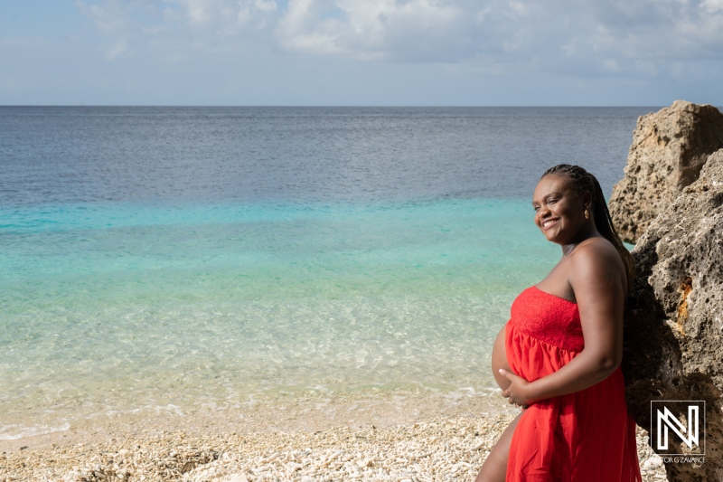 Expecting joy by the serene shores of Curacao, celebrating maternity during a beautiful day at the beach