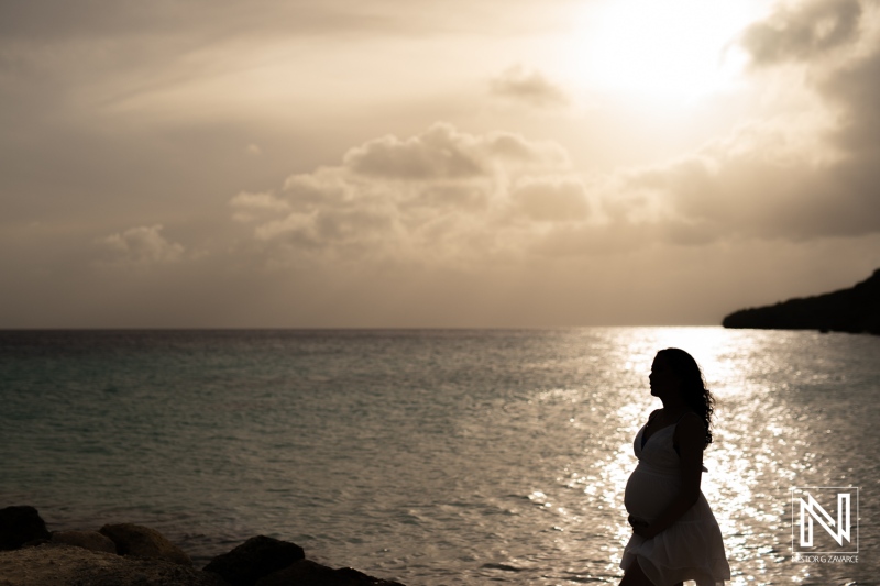 Maternity photoshoot captures serene moments during sunset on the beaches of Curacao