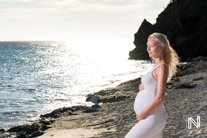 Maternity photoshoot at Playa Porto Mari in Curacao during sunset with calm waves and soft sand
