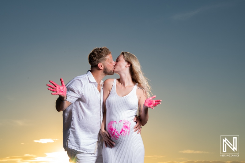 Couple enjoys maternity photoshoot at Playa Porto Mari in Curacao during sunset as they celebrate their new family member