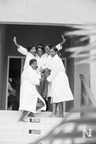 Bridesmaids lifting the bride