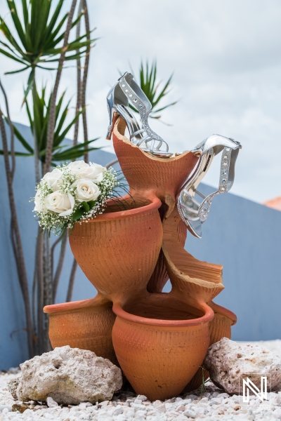 Bride shoes and bouquet on mud vessel