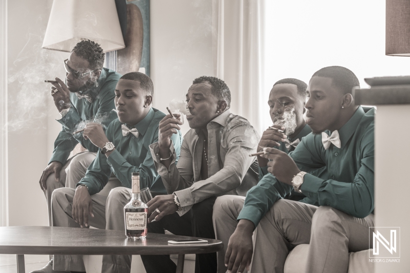Groom and groomsmen smoking cigar
