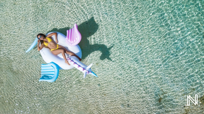 Relaxing on a colorful inflatable in the clear waters of a tropical paradise during a sunny day at the beach