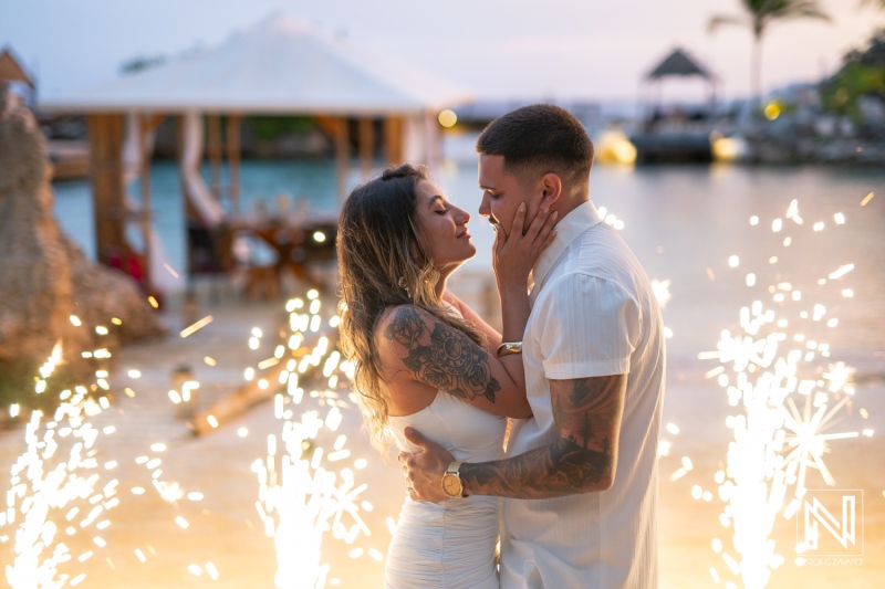 Couple celebrates wedding proposal at Baoase Luxury Resort in Curacao during sunset with sparkling lights