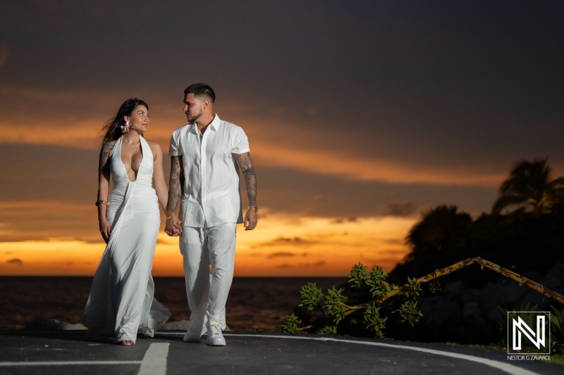 Couple walks hand in hand during a wedding proposal at Baoase Luxury Resort in Curacao at sunset