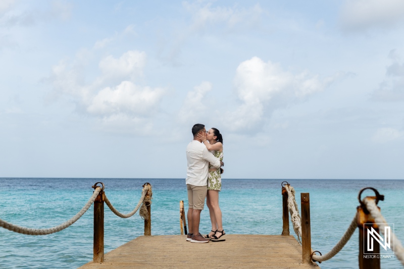 Romantic wedding proposal on Kokomo Beach in Curacao surrounded by serene ocean waters and a picturesque sky
