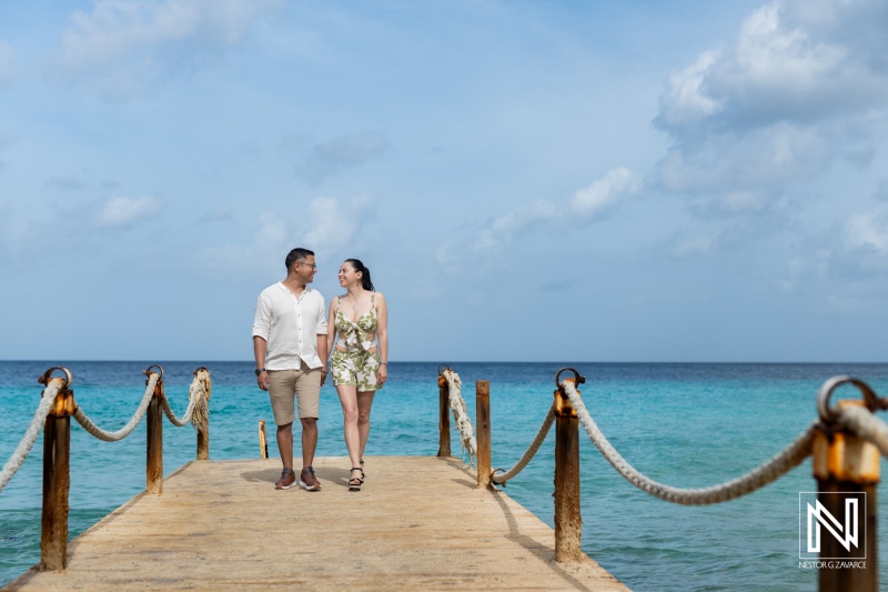 Couple enjoys a romantic wedding proposal moment at Kokomo Beach in Curacao against a stunning ocean backdrop