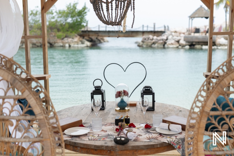 Romantic wedding proposal at Baoase Luxury Resort during sunset in Curacao with heart-shaped decor