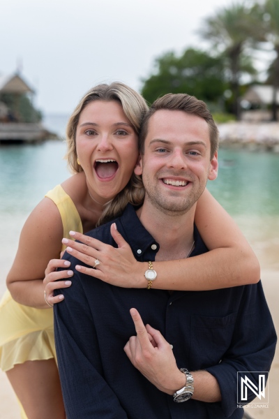 Couple celebrates joyful wedding proposal at Baoase Luxury Resort in Curacao during a stunning sunset