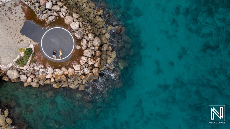 Stunning wedding proposal at sunset near the serene waters of Baoase Luxury Resort in Curacao, capturing a moment of love and happiness