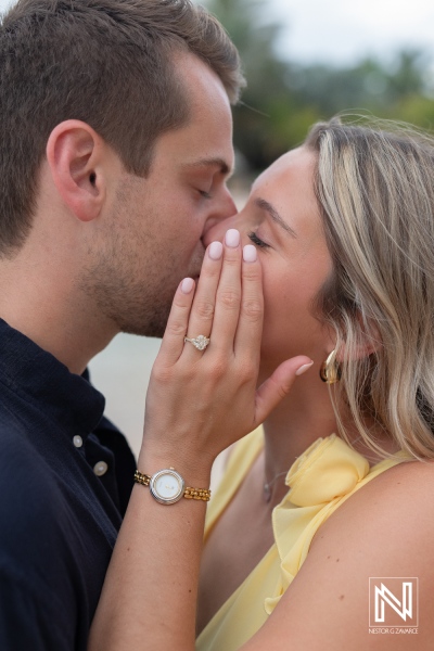 Couple shares intimate kiss during romantic wedding proposal at Baoase Luxury Resort in Curacao at sunset