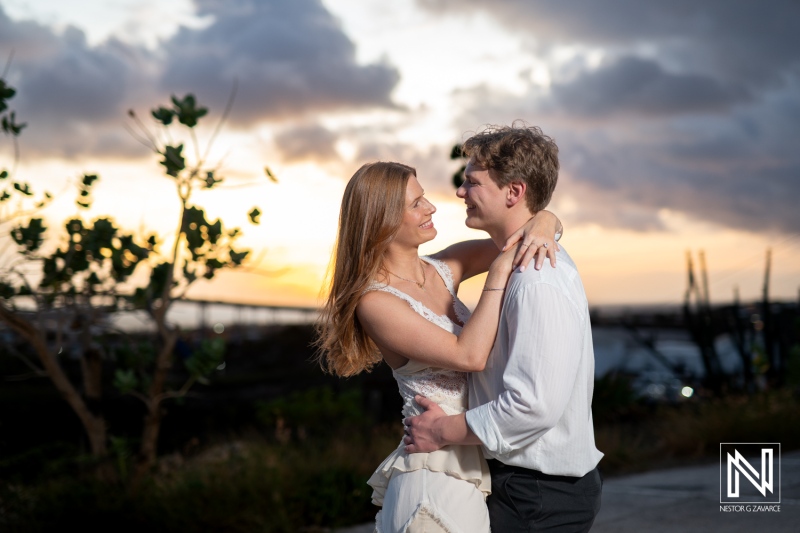 Couple shares a special moment at Fort Nassau during a wedding proposal in Curacao at sunset