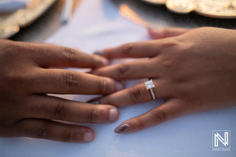 Couple shows engagement ring during wedding proposal at Avila Beach Hotel in Curacao