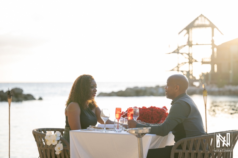 Couple celebrates wedding proposal at Avila Beach Hotel in Curacao during sunset on the beach