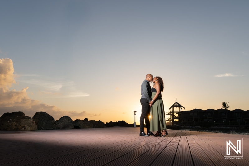 Couple shares moment during wedding proposal at Avila Beach Hotel in Curacao at sunset