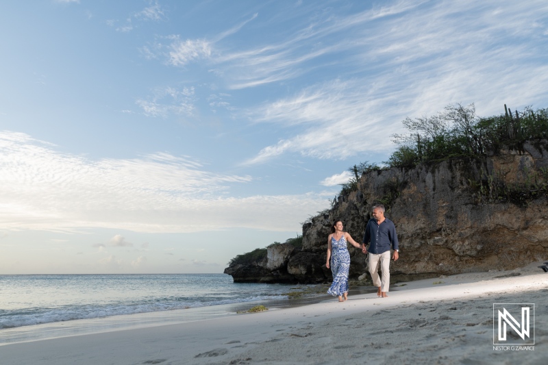 Couple walks on the beach holding hands during a wedding proposal at Grote Knip in Curacao