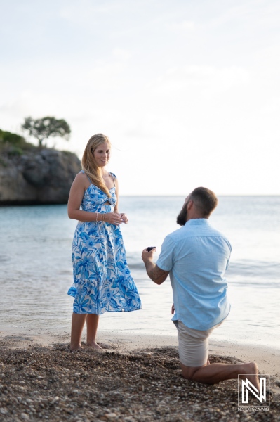 Couple enjoys a romantic wedding proposal at Playa Jeremi during a beautiful sunset in Curacao