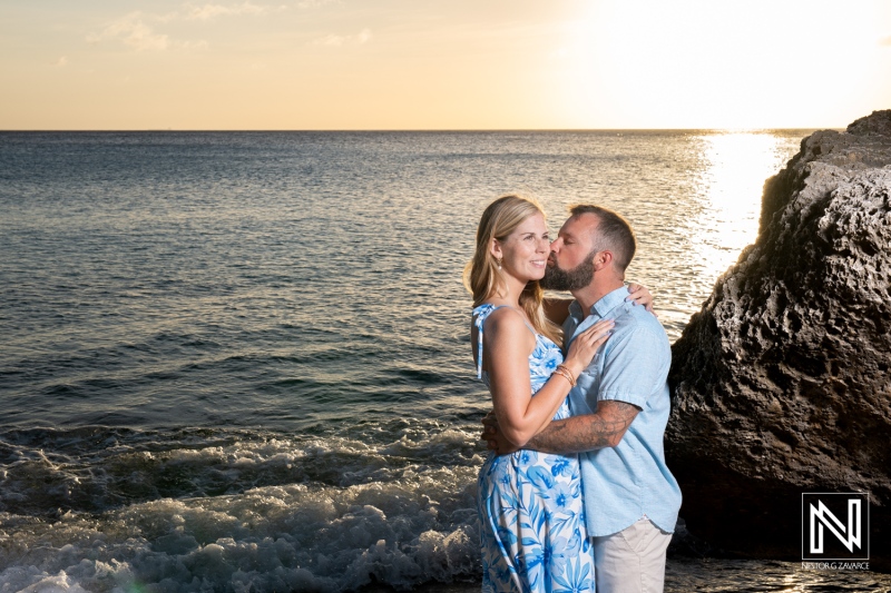 Couple enjoys romantic sunset moment during wedding proposal at Playa Jeremi in Curacao