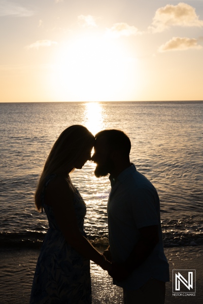 Couple enjoys romantic sunset proposal at Playa Jeremi in Curacao amidst serene ocean views