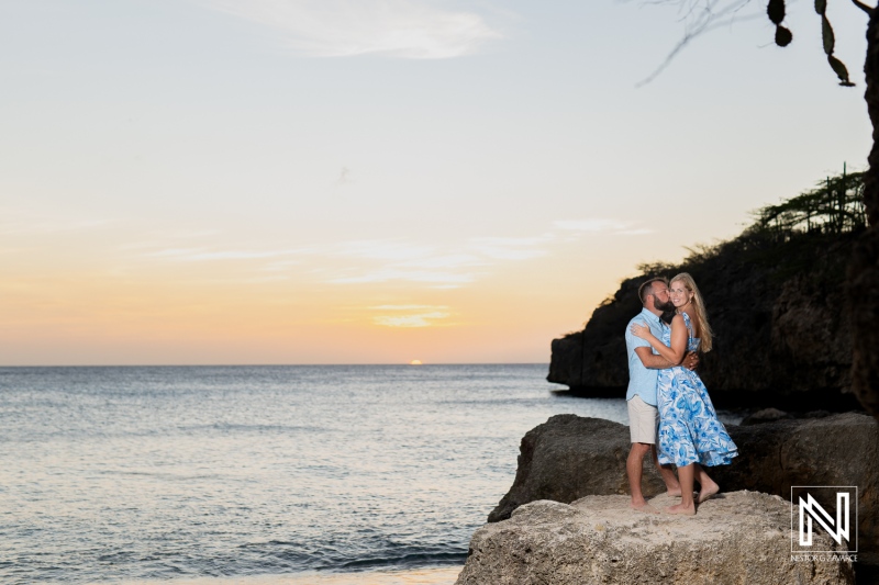 Couple enjoys a romantic wedding proposal at sunset on the picturesque Playa Jeremi in Curacao, surrounded by stunning coastal beauty